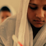 A young girl working hard in school.